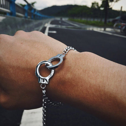 Fuchsia Molly handcuffs bracelet featuring a sleek metallic design and adjustable chain for stylish wear.