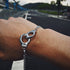 Fuchsia Molly handcuffs bracelet featuring a sleek metallic design and adjustable chain for stylish wear.