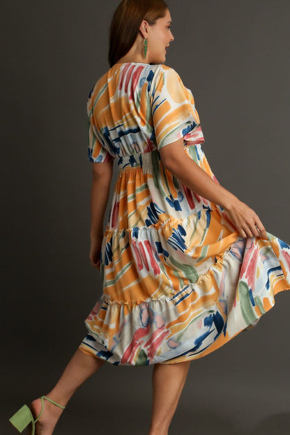 Umgee abstract print flutter sleeve frill tiered midi dress, showcasing its flowing fabric and vibrant pattern.