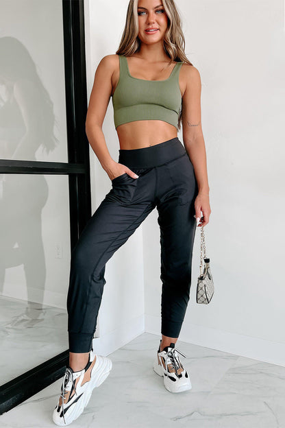 Black high waist joggers with exposed seams and pockets from Carmine Juneberry, stylish and comfortable for casual wear.