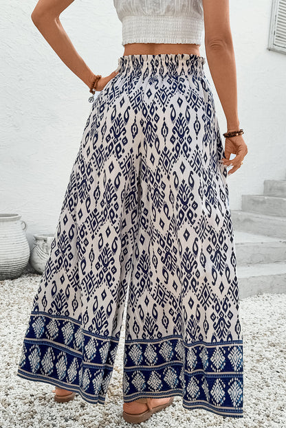 Women’s boho smocked high waist wide leg pants by Byzantium Bay, featuring flowy fabric and relaxed fit.