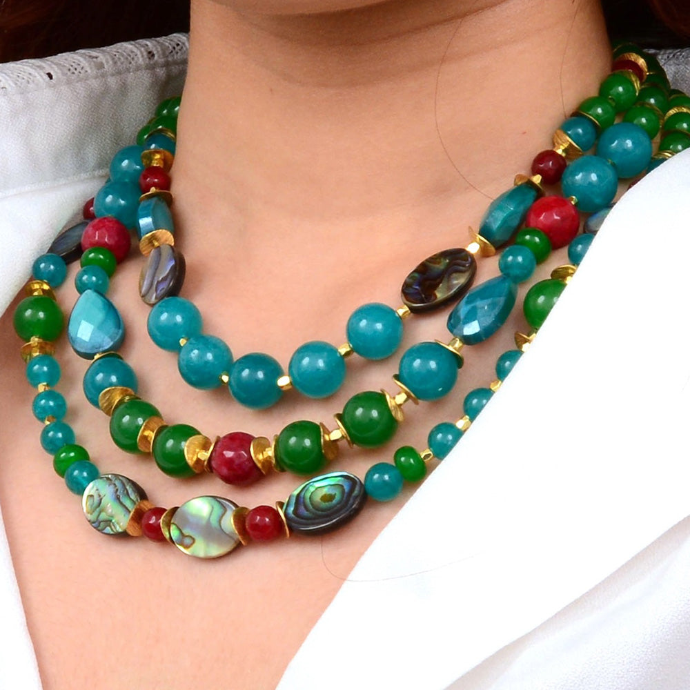 Jeweled green agate statement necklace with gold accents, featuring intricate design and sparkling gemstone details.