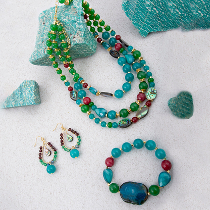 Jeweled green agate statement necklace with gold accents, featuring intricate jewelry design and vibrant gemstone details.