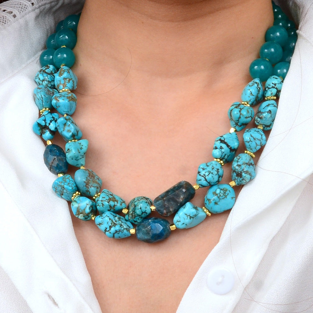 Aurora chunky blue apatite statement necklace with gold accents, featuring large polished blue gemstone beads and elegant jewelry design