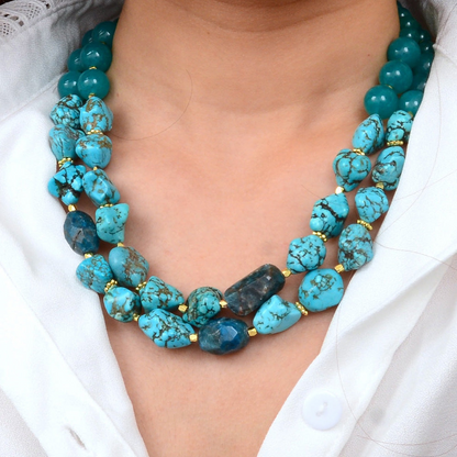 Aurora chunky blue apatite statement necklace with gold accents, featuring large polished blue gemstone beads and elegant jewelry design