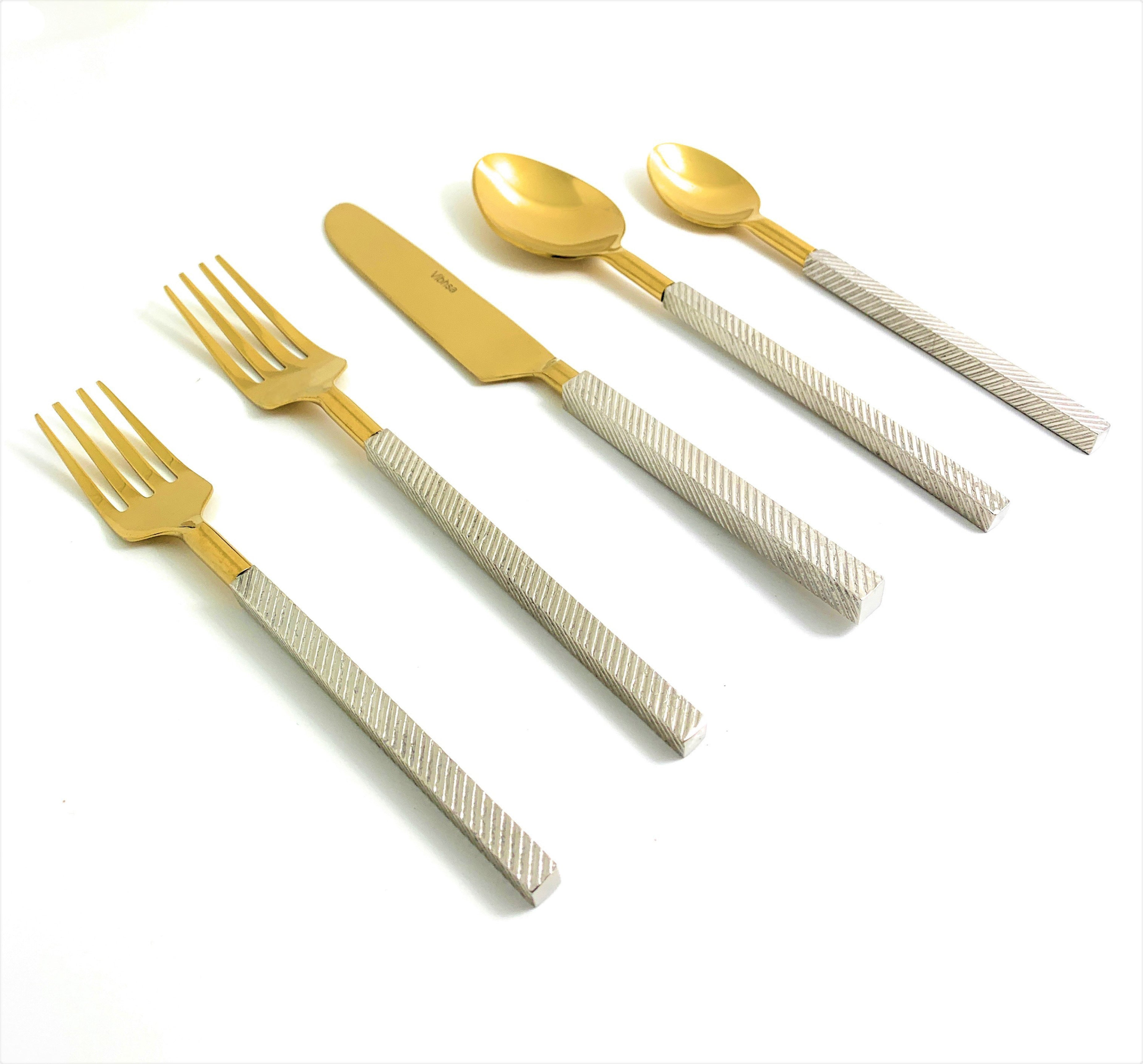 Start2Finish modern stainless steel flatware set of 20 pieces, including forks, knives, spoons, and serving utensils on a clean table.