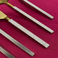 Set of 20-piece modern stainless steel flatware from Start2Finish, including forks, knives, spoons on a neutral background.