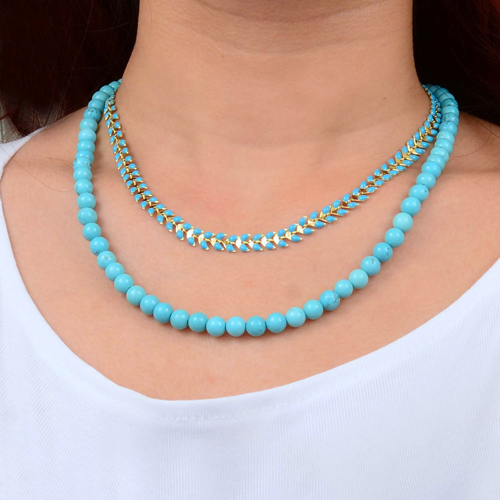 Blue turquoise magnesite layered necklace with a golden chevron pendant, stylish jewelry piece from Start2Finish.