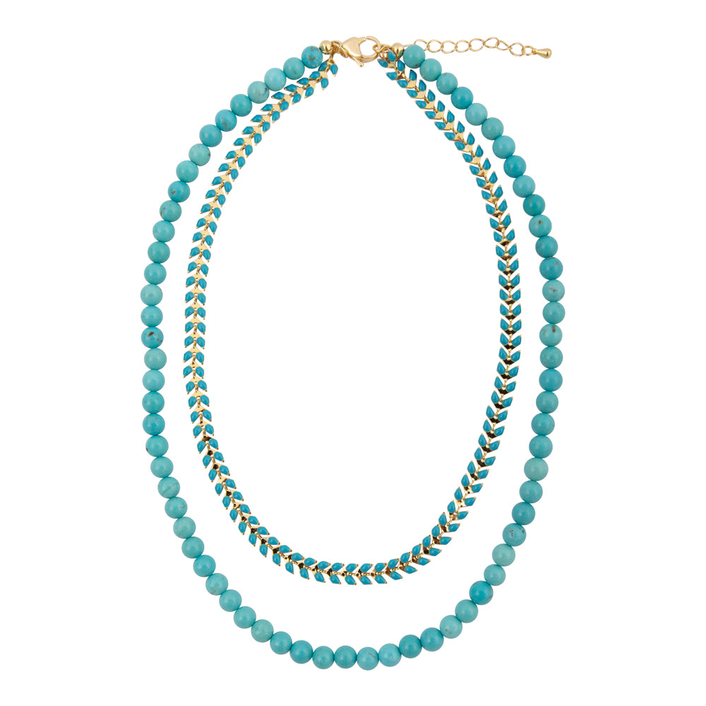 Blue turquoise magnesite layered necklace with golden chevron accents, jewelry piece featuring vibrant stones and stylish design.