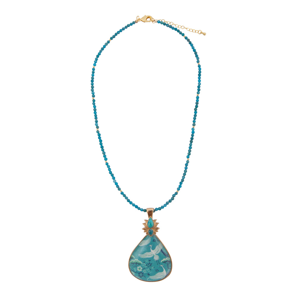 Heron Flight Blue Teal Apatite pendant necklace with gold accents, featuring a detailed bird design on a chain.