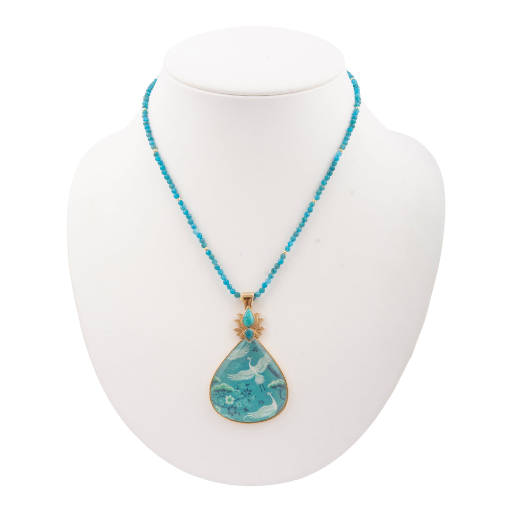Heron Flight Blue Teal Apatite pendant necklace with golden chain from Start2Finish, showcasing a detailed bird design and vibrant stone.