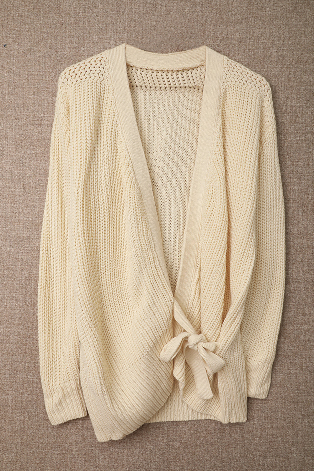 Beige wrap V-neck sweater with side tie from Harlequin Daisy, soft knit fabric, styled on a model.