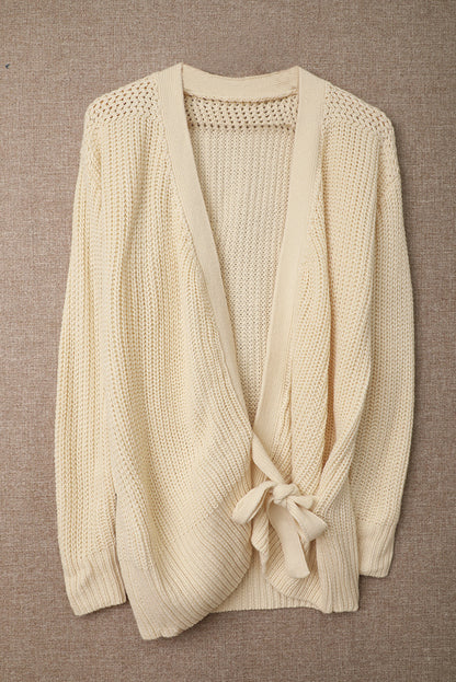 Beige wrap V-neck sweater with side tie from Harlequin Daisy, soft knit fabric, styled on a model.