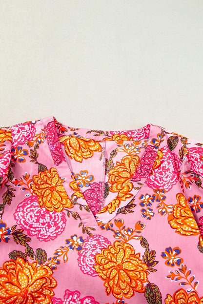 Pink floral bubble sleeve V-neck ruffled mini dress by Carmine Juneberry, featuring a feminine design with floral patterns and ruffle details.