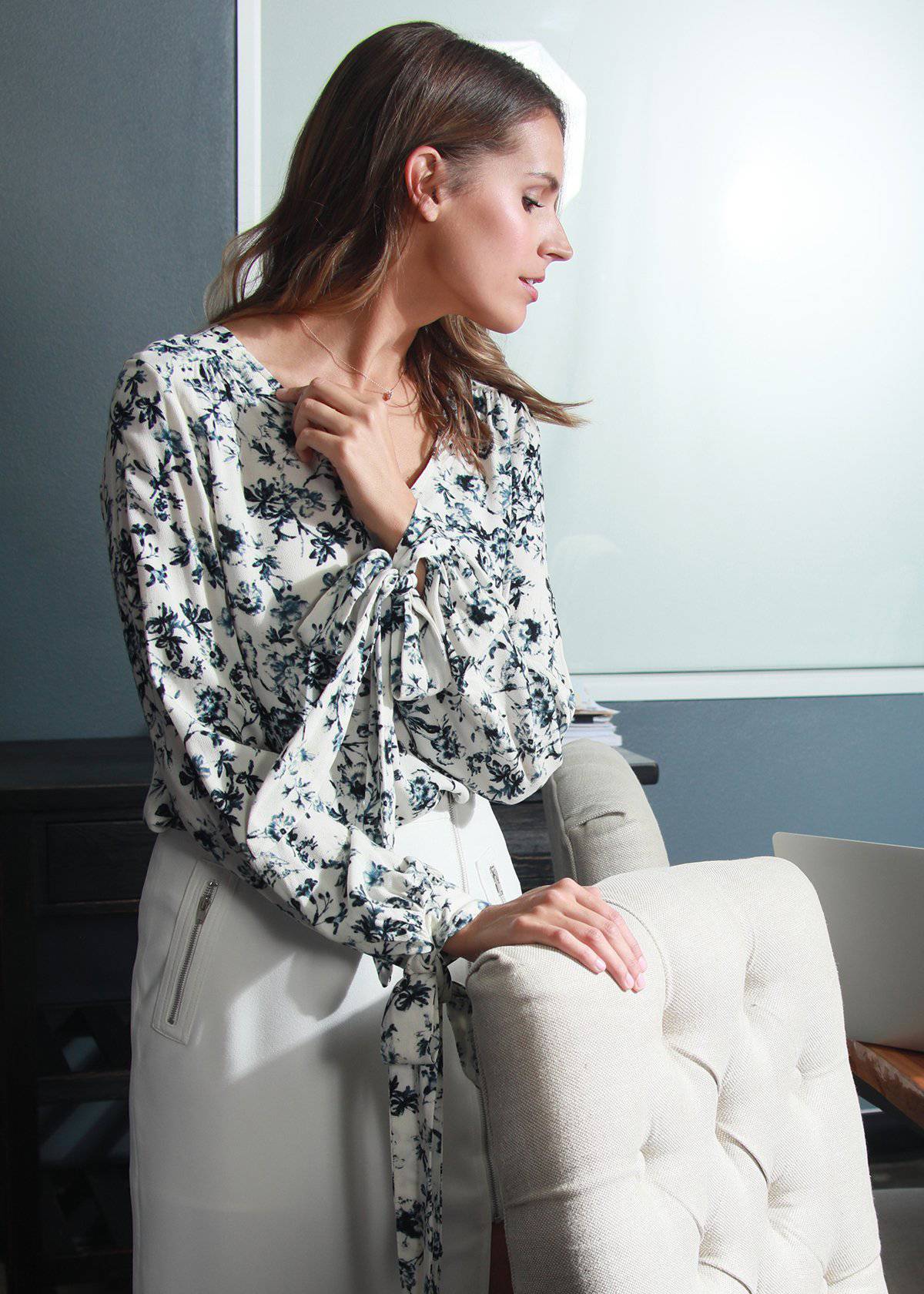 Ivory floral garden V-neck tie cuff blouse from Lemon Hera, featuring a feminine design with ruffled details and long sleeves.