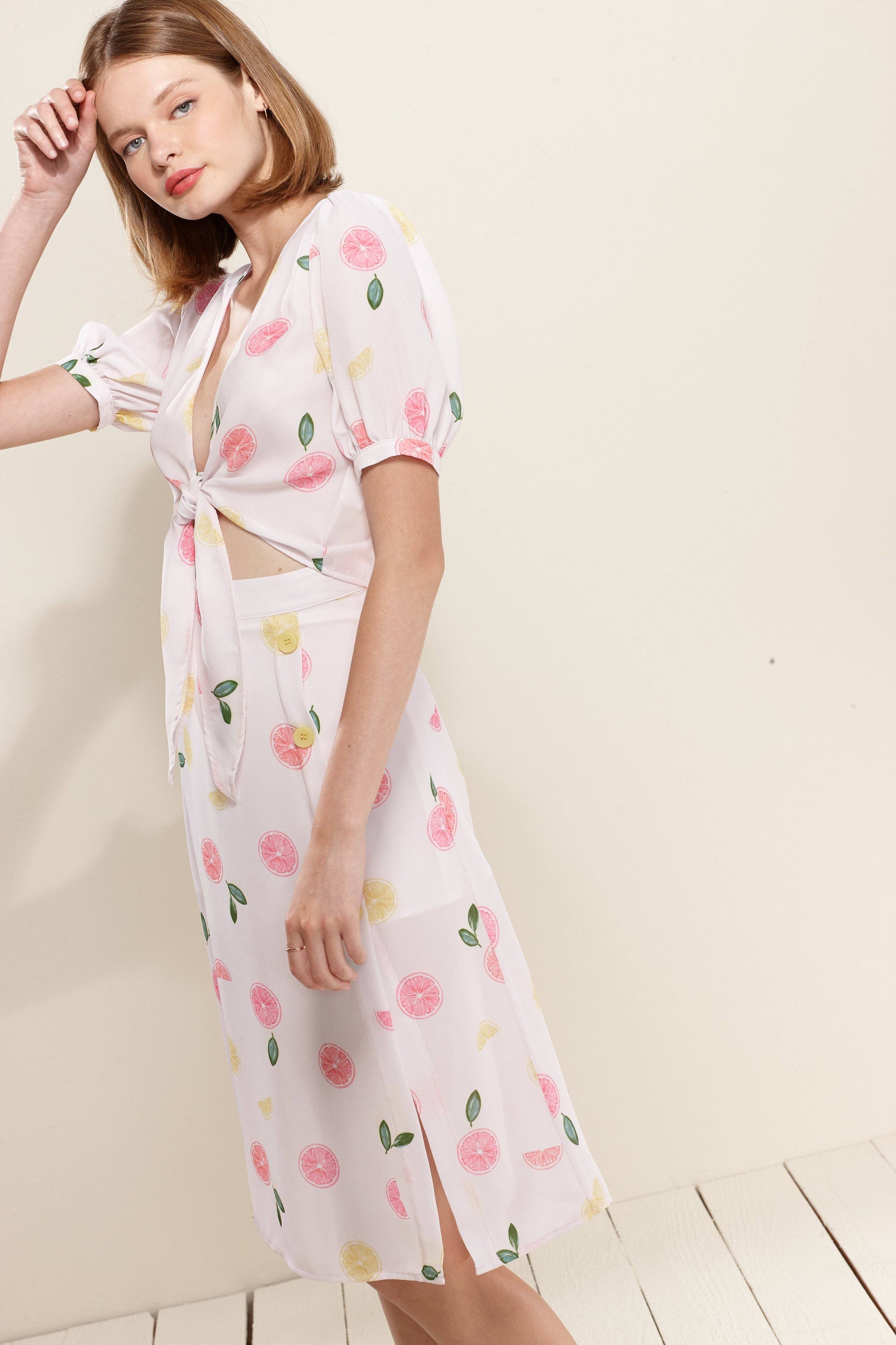 Lemon Hera button front midi skirt in vibrant Fruit Punch color, featuring a flowy design and stylish button details.