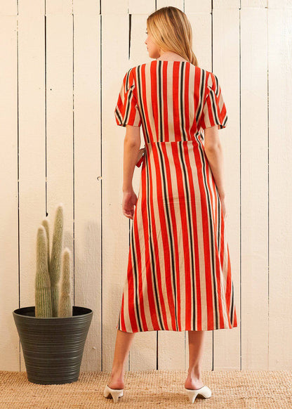 Lemon Hera puff sleeve wrap dress in Poppy Multi featuring vibrant floral print and fitted waist on model.