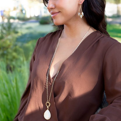 White mother of pearl pendant necklace with golden accents, featuring intricate jewelry design by Start2Finish.