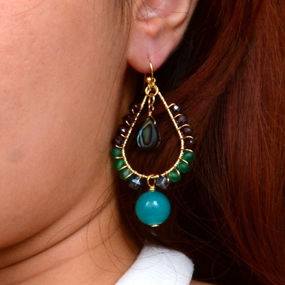 Jeweled blue jade and gold drop earrings featuring intricate jewelry design with sparkling accents.
