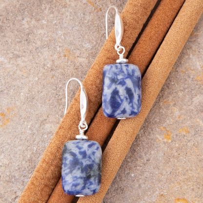 Denim blue quartz silver drop earrings featuring sleek jewelry design with silver hooks and vibrant blue gemstones.