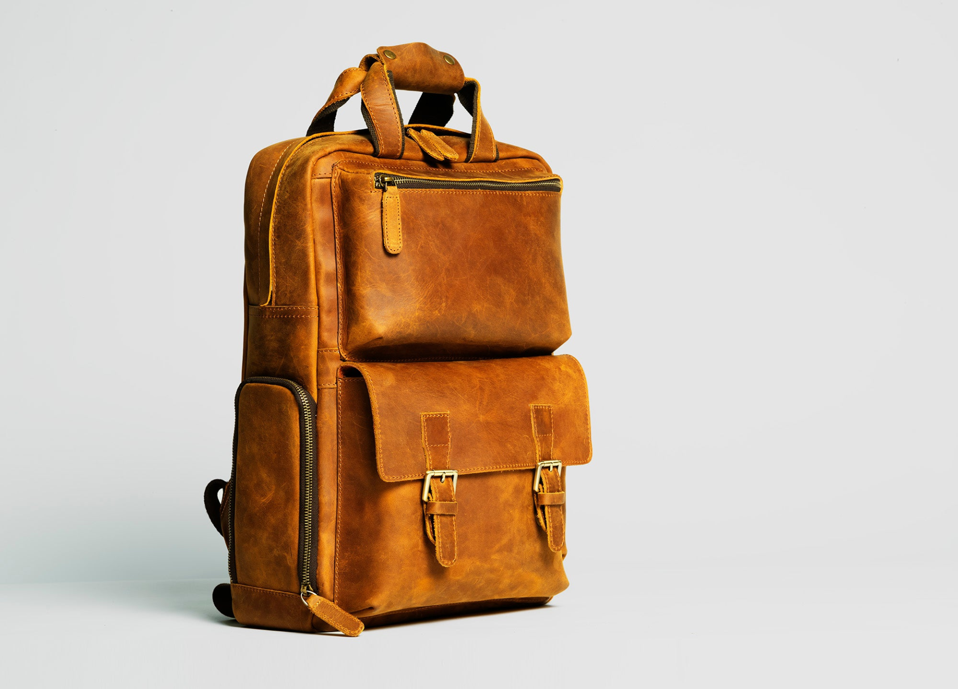 Start2Finish The MANN large leather camera backpack with multiple compartments and adjustable straps for versatile photography accessories.