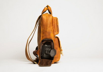 Large leather camera backpack from Start2Finish with multiple compartments and adjustable straps, designed for carrying photography accessories.