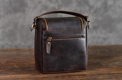 Small leather camera bag by Start2Finish, with a compact design, leather exterior, and camera lens case for accessories.