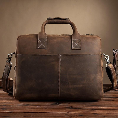 Vintage leather messenger bag from the Welch Briefcase collection by Start2Finish, showing the front view with leather strap and buckle.
