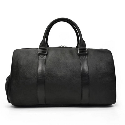 Vintage leather duffle bag from Start2Finish, The Endre Weekender, with sturdy handles and classic design for travel accessories.