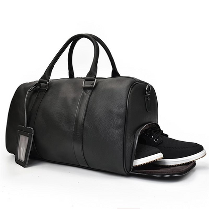 Vintage leather duffle bag from Start2Finish, The Endre Weekender, featuring sturdy handles and spacious interior for travel accessories.