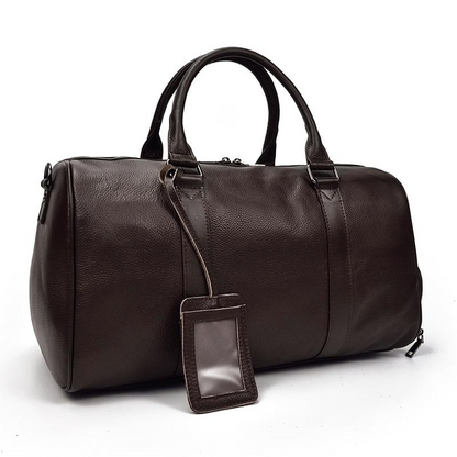 Vintage leather duffle bag, The Endre Weekender accessory by Start2Finish, with sturdy handles and spacious interior for travel.