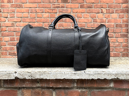 Vintage leather duffle bag from Start2Finish, The Endre Weekender, with sturdy handles and spacious interior for travel accessories.