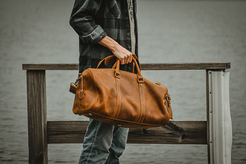 Large leather duffle bag from the Start2Finish Dagny Weekender collection, showing the spacious design and sturdy leather handles.