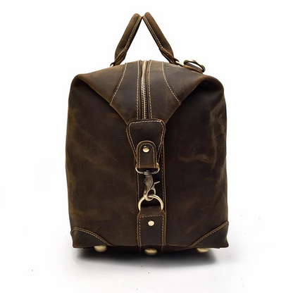 Vintage leather Eira Duffle Bag by Start2Finish, stylish weekender accessory with sturdy handles and spacious interior.