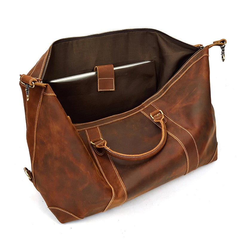 Vintage leather Eira duffle bag by Start2Finish, a stylish weekender accessory with sturdy handles and spacious interior.