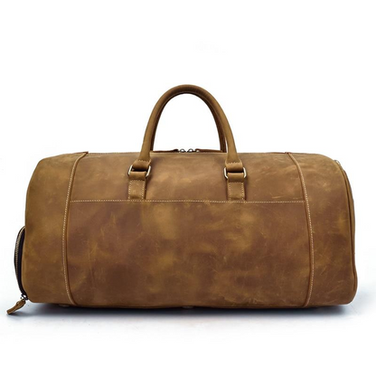 Handmade leather duffle bag from Start2Finish Bard Weekender, with sturdy handles and spacious interior for travel accessories.