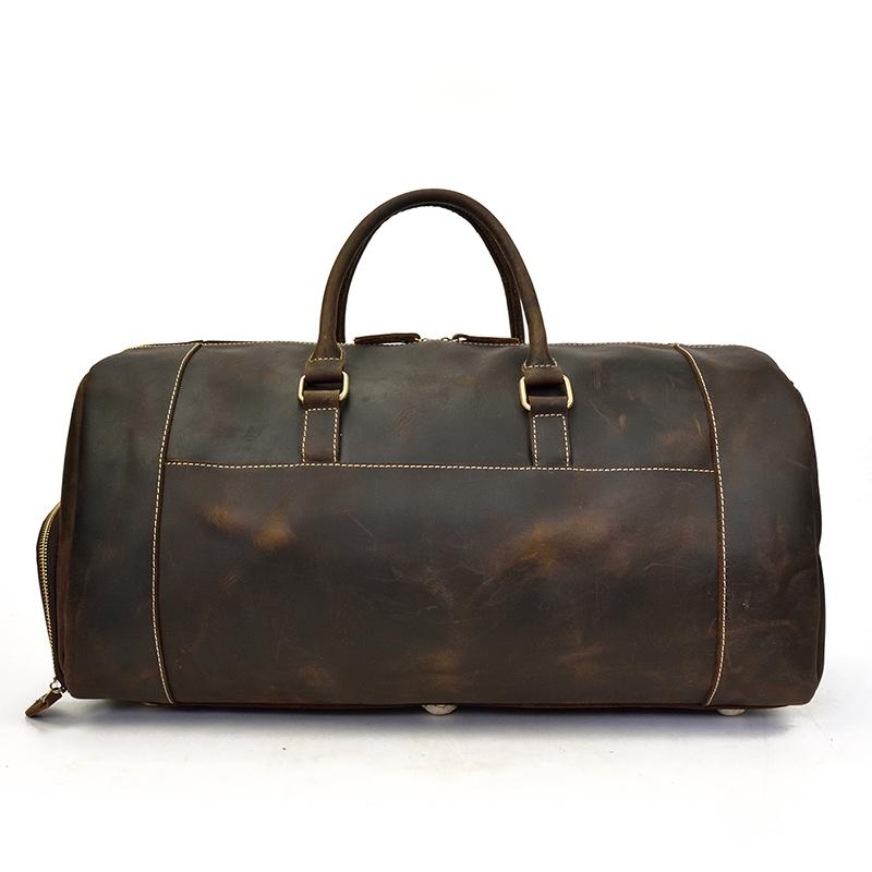 Handmade leather duffle bag from Start2Finish, The Bard Weekender, with sturdy handles and spacious interior for travel accessories.