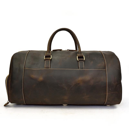 Handmade leather duffle bag from Start2Finish, The Bard Weekender, with sturdy handles and spacious interior for travel accessories.