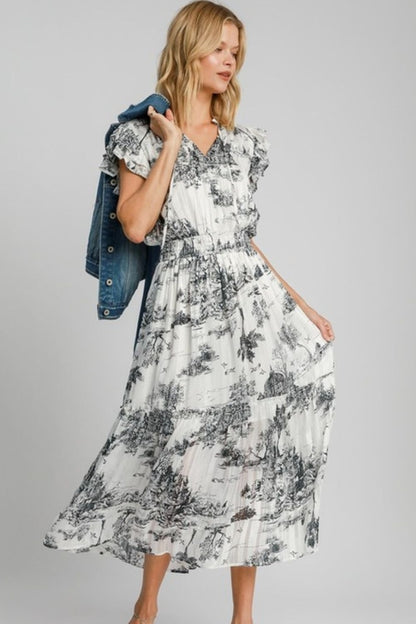 Full size Umgee landscape print midi dress in two-tone design by Jade Icarus, displayed in an automotive-themed setting.