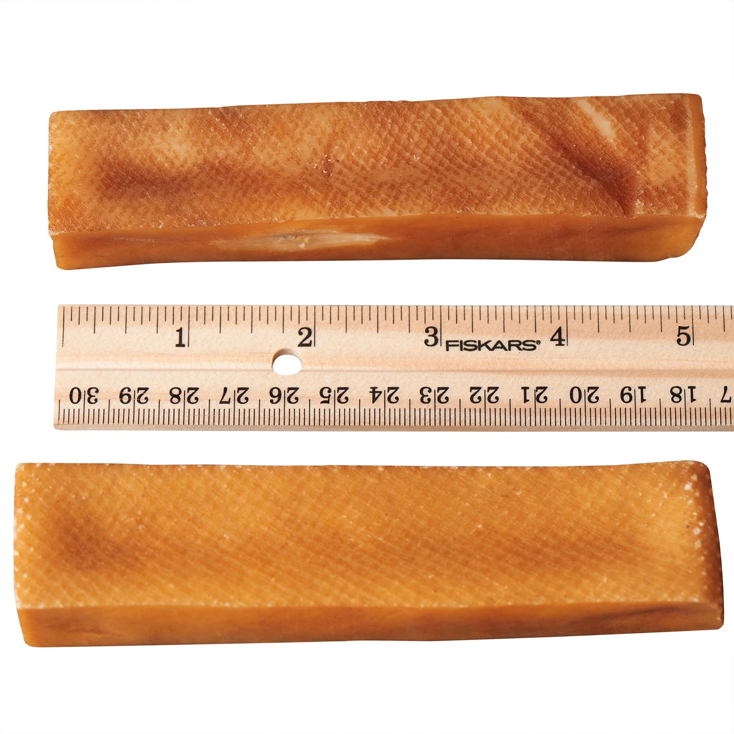 Two Yak Cheese Churpi dog chews from Harlequin Ganymede, 5.5 oz pack, showing the textured, natural dog treats on a white background.