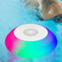 Salmon Lucky Floatilla Bluetooth waterproof speaker with LED lights, designed for pool use, showing the device floating on water.