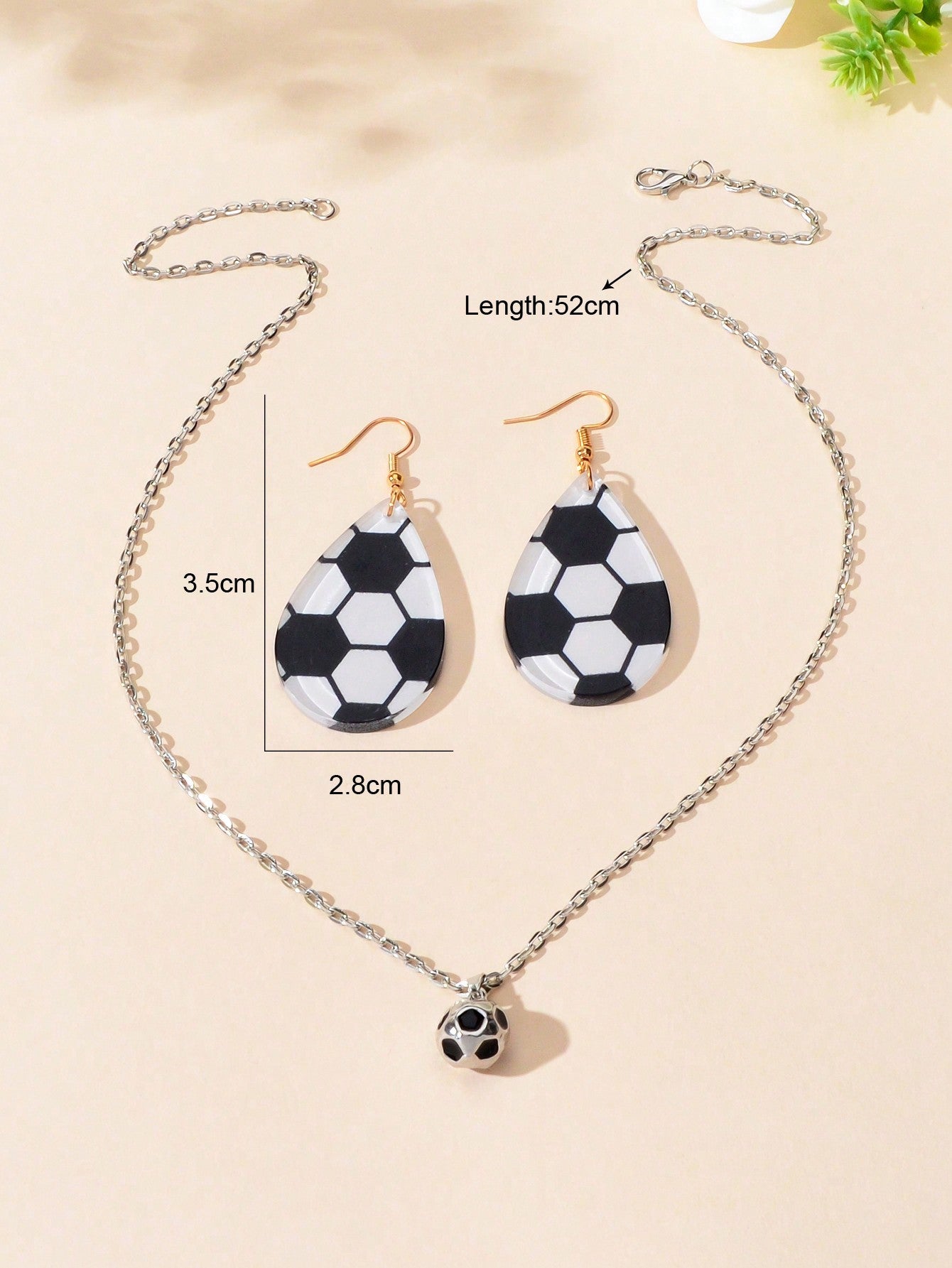 White Demeter sporty soccer pendant necklace and earrings set featuring soccer ball charms on silver jewelry with a modern design.