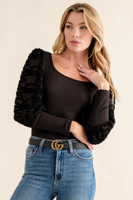 Textured puff sleeve bodysuit by Jade Icarus featuring intricate detailing and a fitted silhouette.