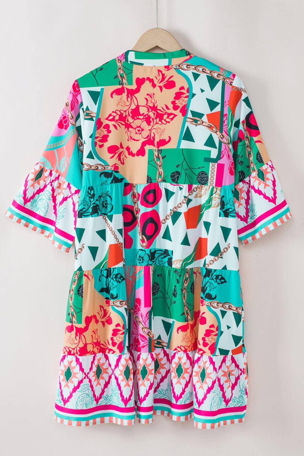Multicolour abstract printed half sleeve mini dress with notched neck by Carmine Juneberry, shown on a model.