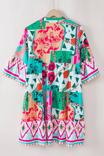 Multicolour abstract printed half sleeve mini dress with notched neck by Carmine Juneberry, shown on a model.