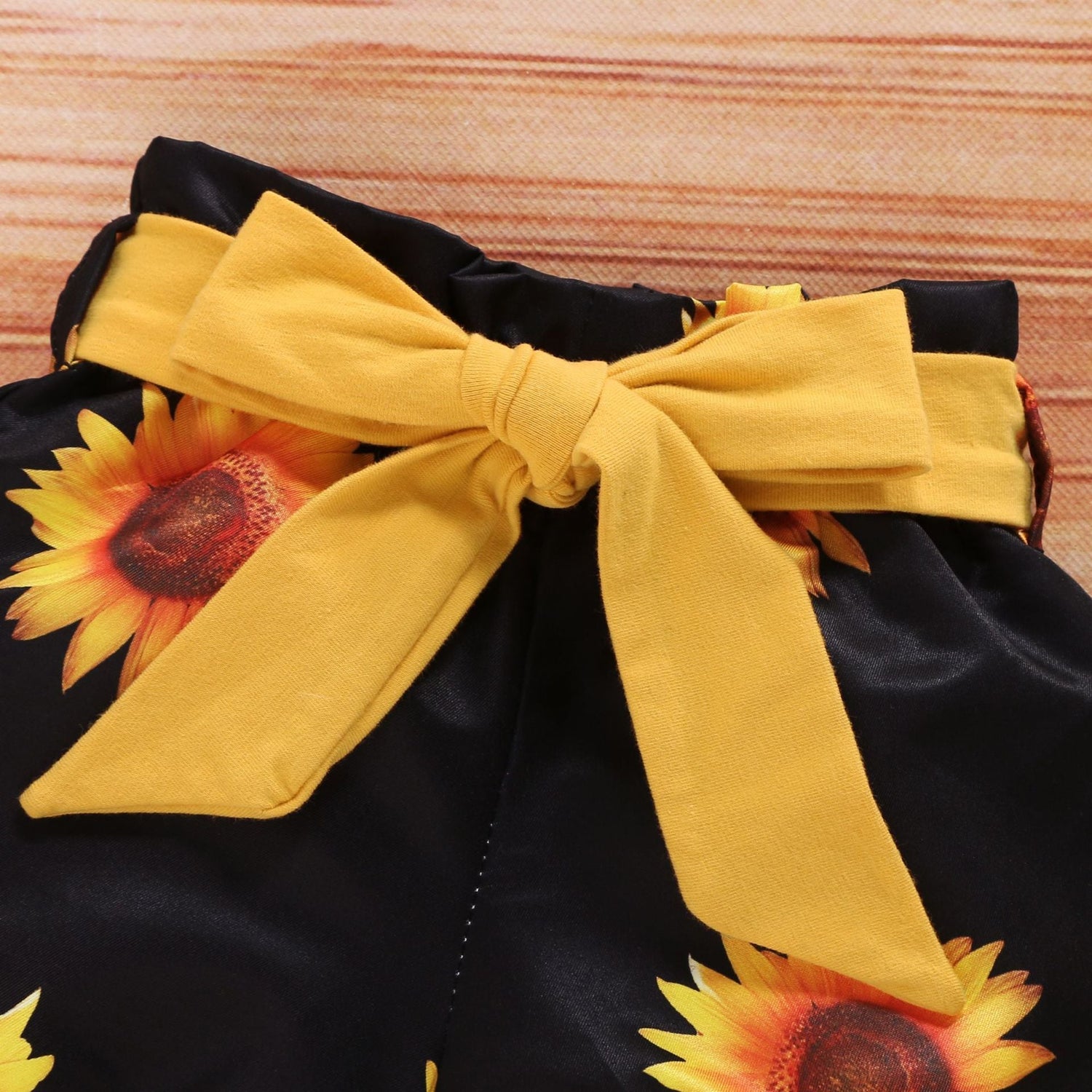 SunnyBloom™ baby girl sunflower outfit featuring a dress, matching headband, and bloomers from Carmine Juneberry.