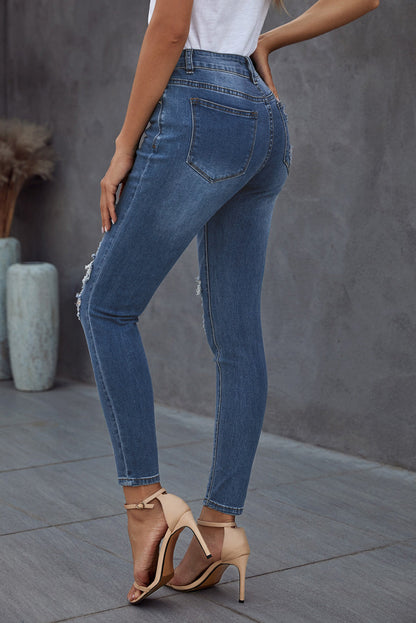 Blue hollow-out vintage skinny ripped jeans by Harlequin Daisy, showcasing distressed denim with a fitted silhouette.