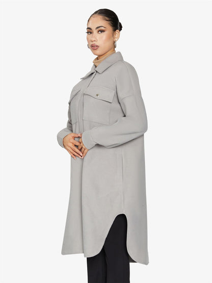 Rose Eleusis oversized longline shacket in neutral fabric, showing a relaxed fit with large front pockets and button closure.