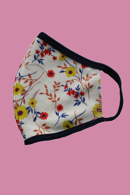 Kids reusable cloth face mask by Indigo Arrowwood, designed for children, featuring colorful patterns and comfortable fit.