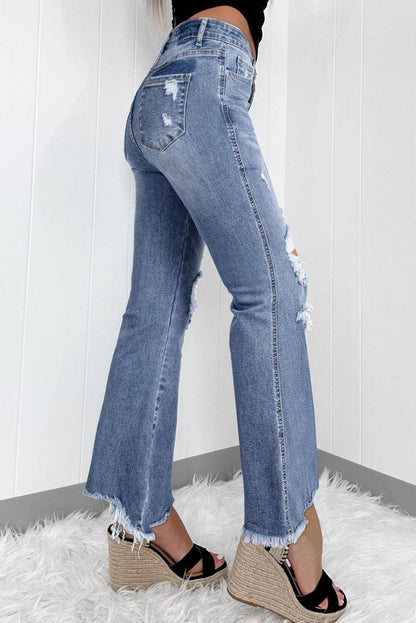 Dusk blue high-rise ripped flared jeans by Carmine Juneberry with distressed hem and stylish fit, displayed on a white background.